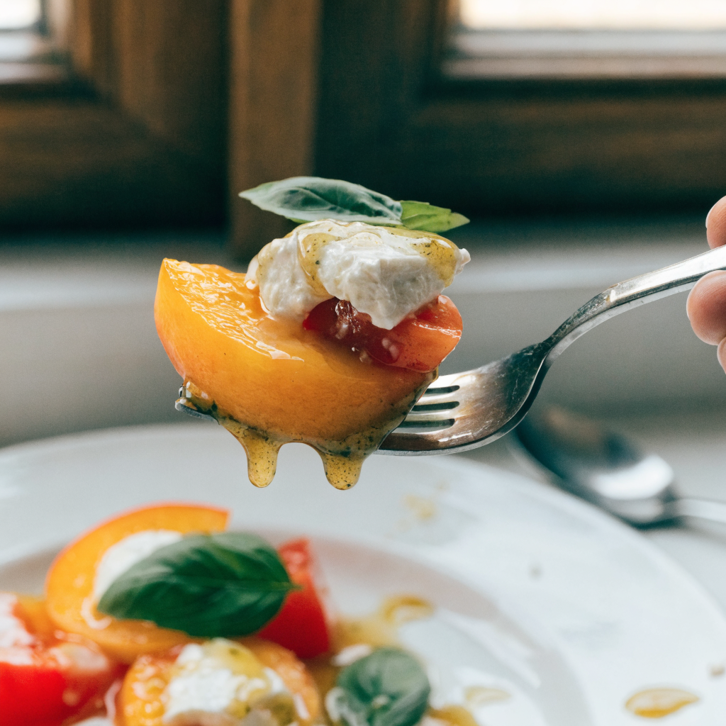 Close-up of peach tomato caprese salad with lemon-pesto vinaigrette